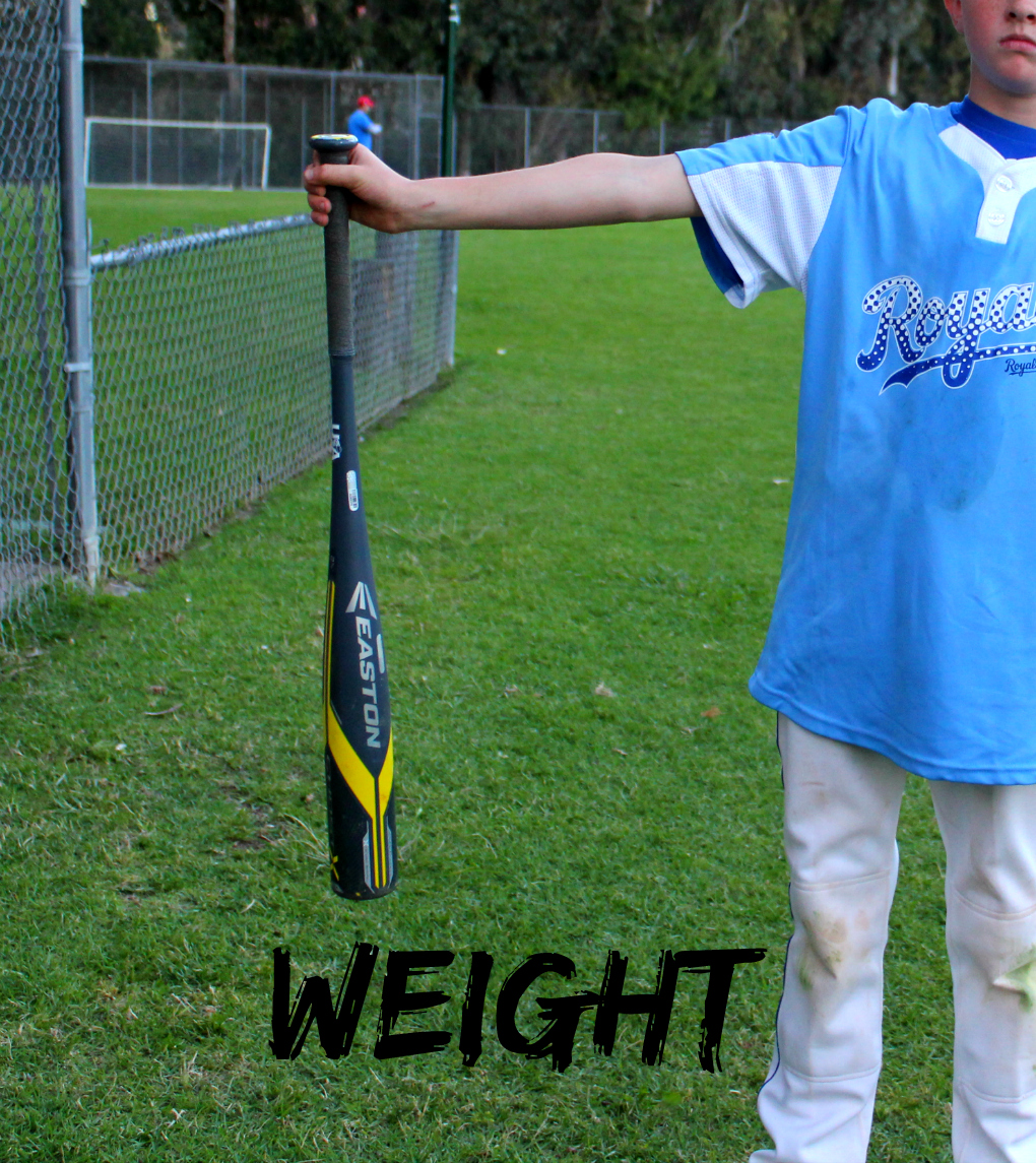 example of child holding out bat to test weight